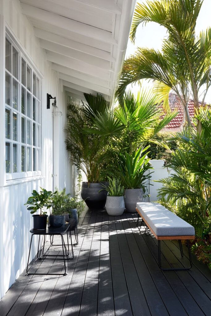 1. Lush Porch with Black Decking and Tropical Flair